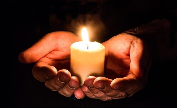 Image of a hand holding candles